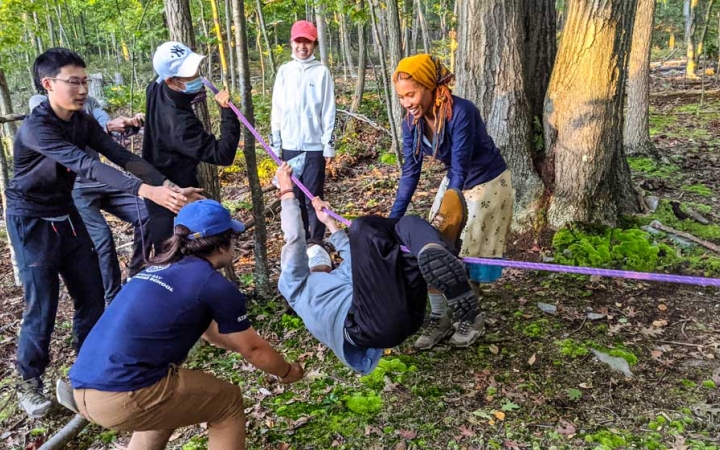 a group of teams participate in a team building exercise on an outward bound trip